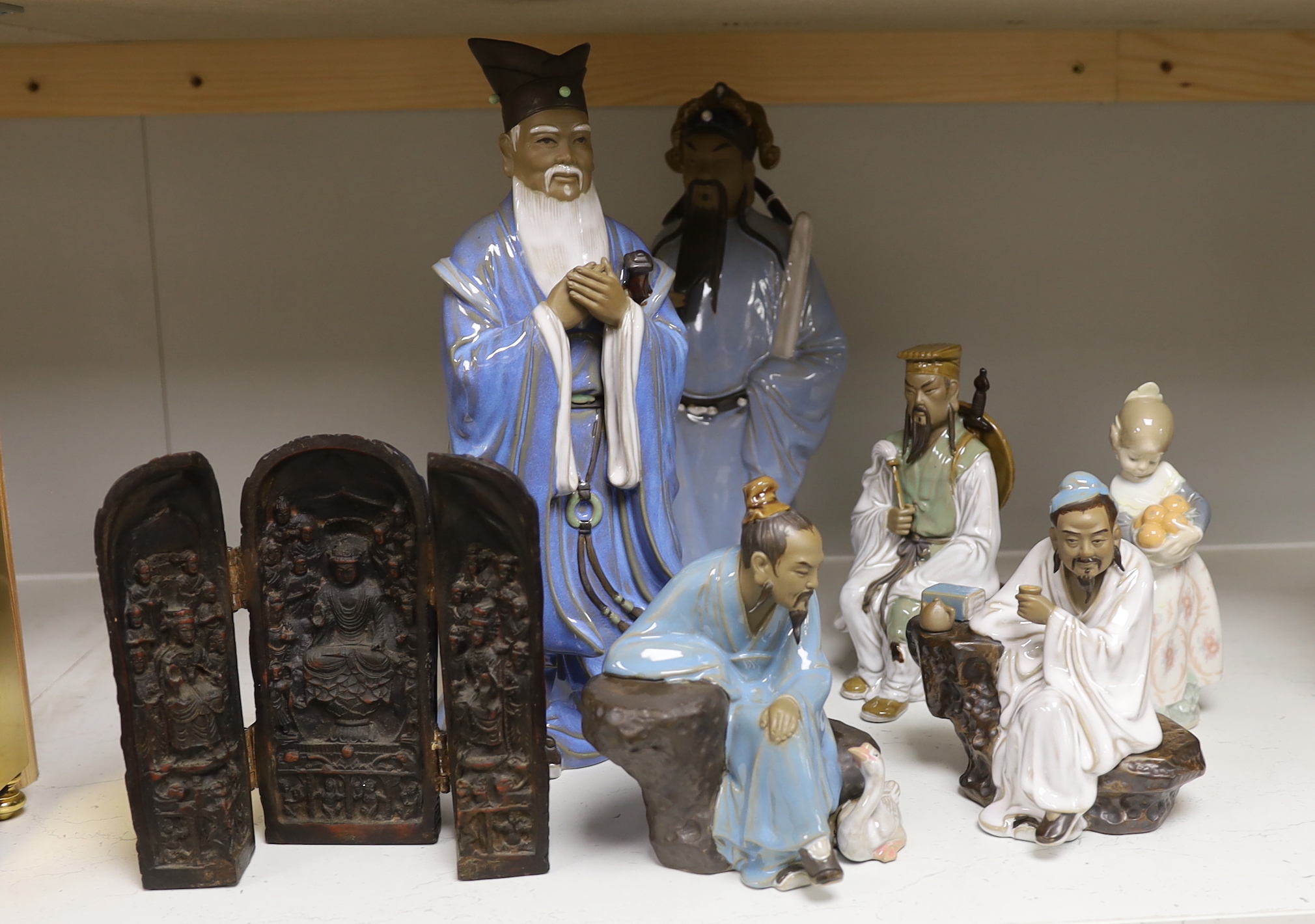 A group of Chinese Shiwan stoneware figures, a composition triptych shrine and a Lladro figure, tallest 33cm high